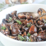 close up of balsamic mushrooms in a white serving bowl