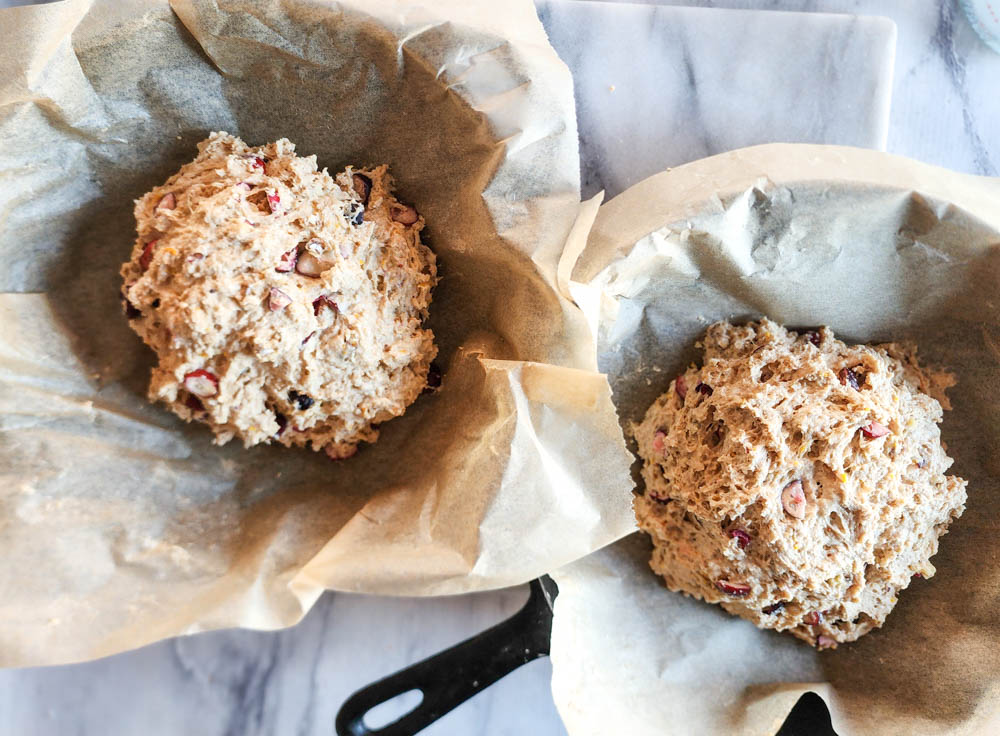 two mounds of dough in two cast iron pans