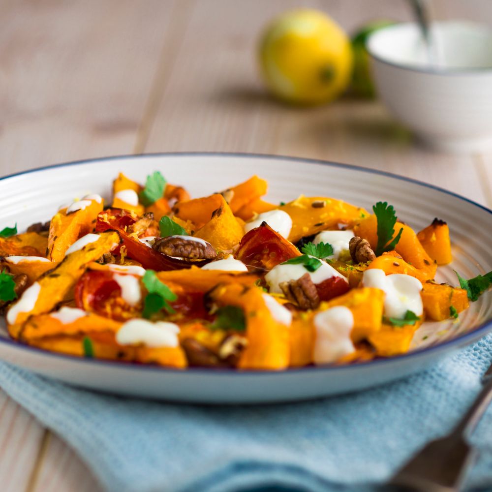 butternut squash cubes in a bowl with parsely