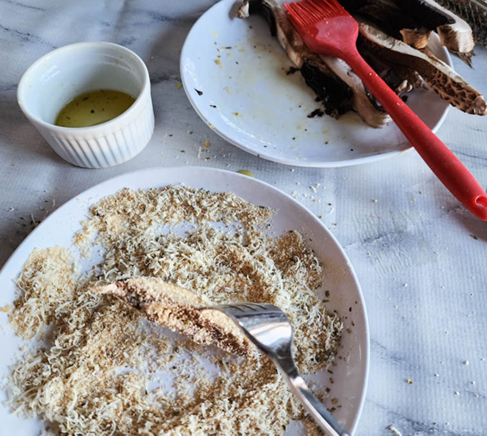 process photo of mushroom slices dipped into bread crumb mixture