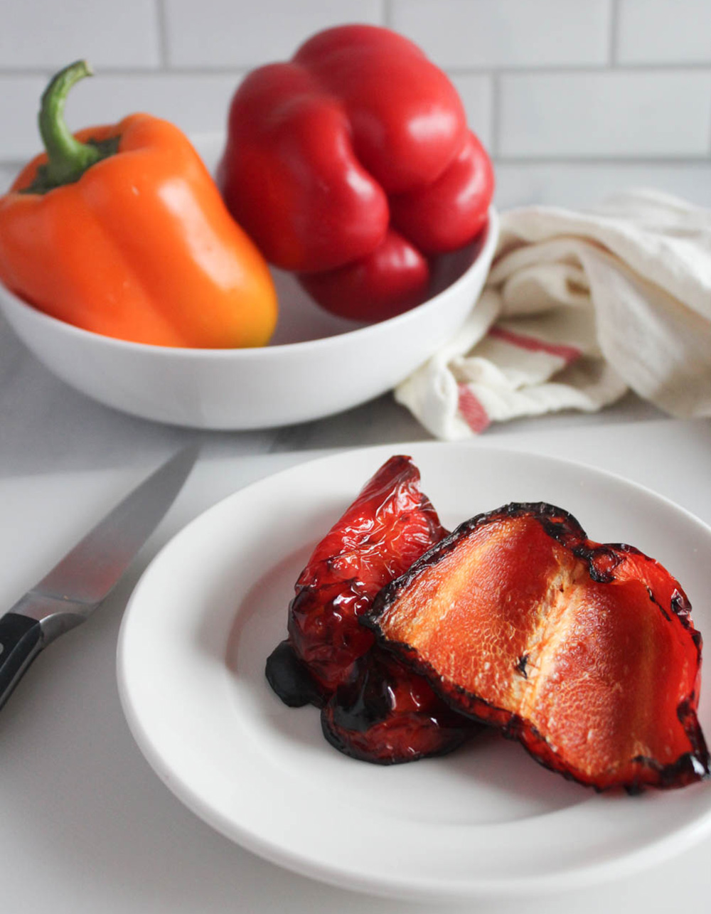 roasted pepper halves on a white plate