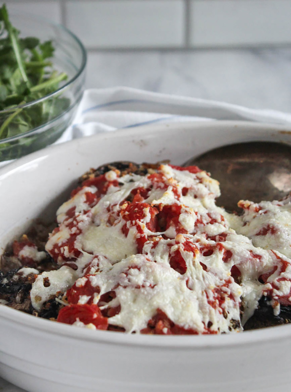 a close up of stuffed mushrooms portobello in a casserole