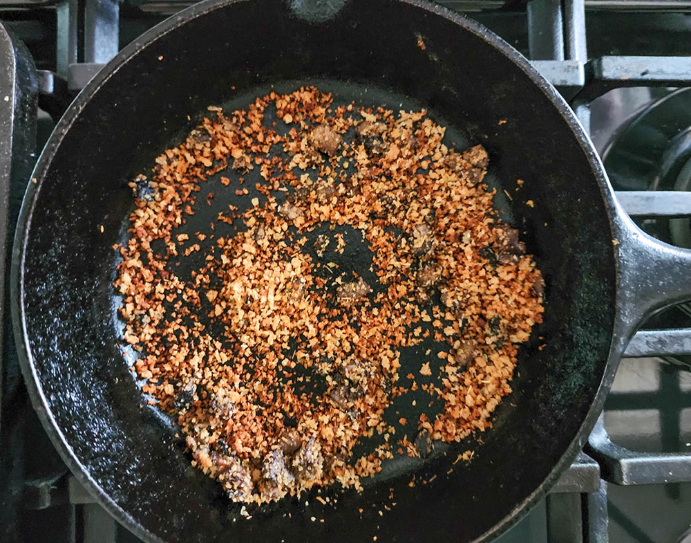 a picture of bread crumbs cooking in a skillet