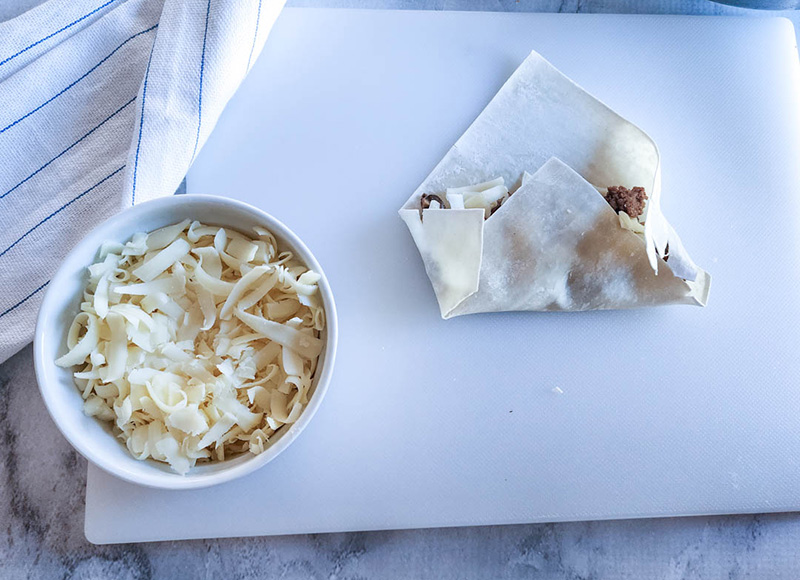 egg roll wrapping process step bottom folded over filling