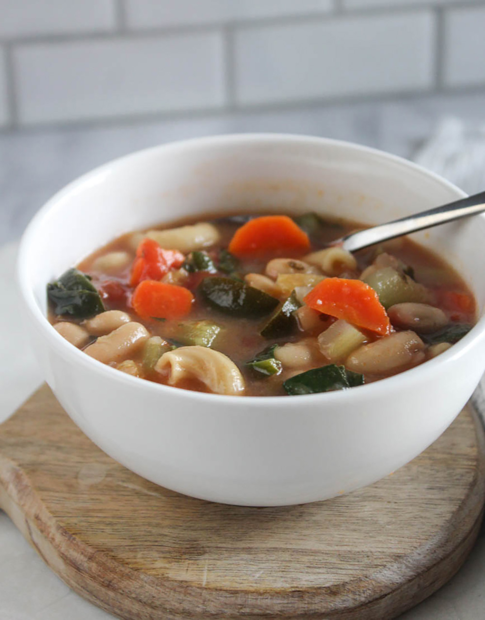 cooked soup in a bowl with a spoon close up