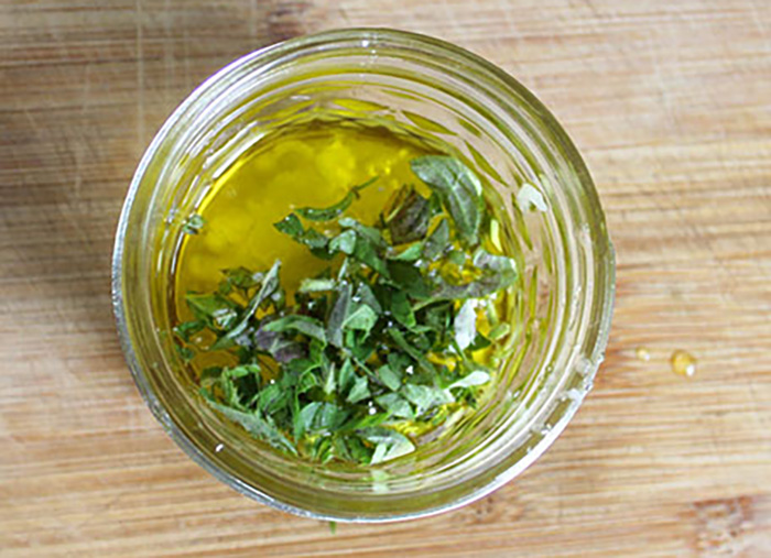 a picture of greek salad dressing ingredients in a small jar