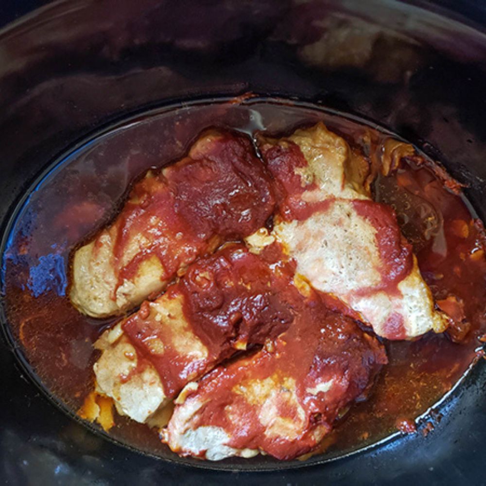 honey garlic chops step 4. Four chops cooked with sauce in a slow cooker