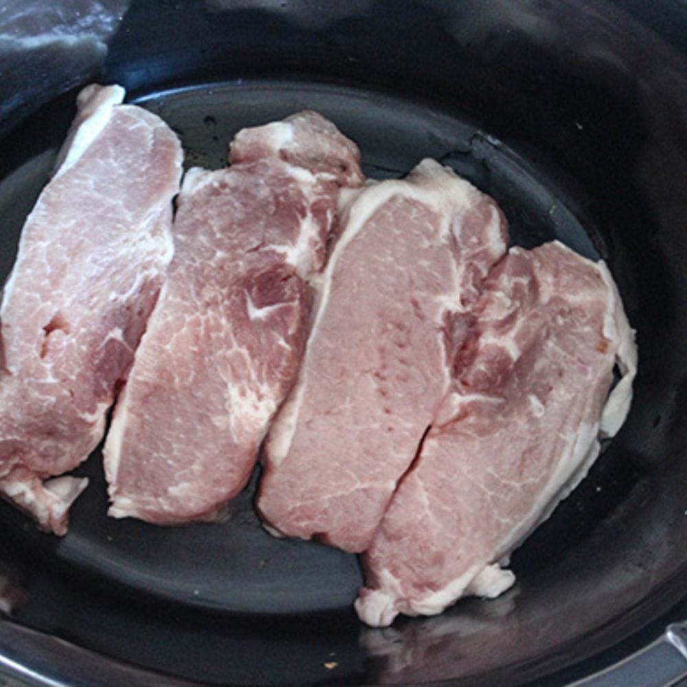 process step 1: 4 boneless pork chops in a slow cooker