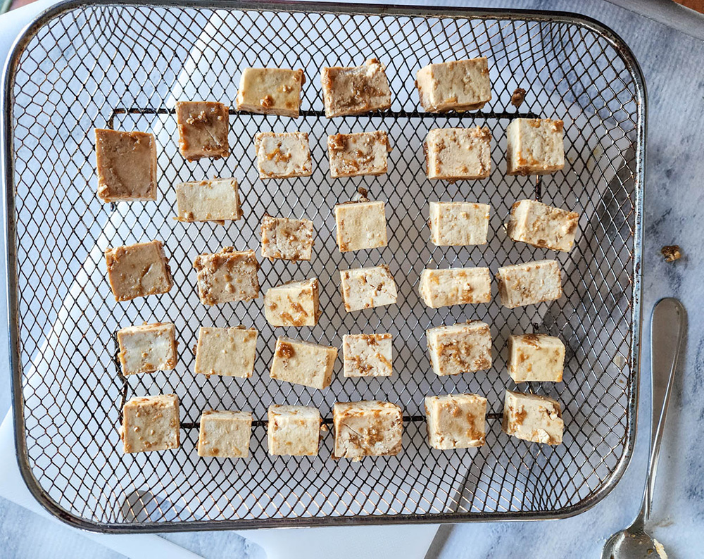 Tofu pieces on a tray ready for the air fryer