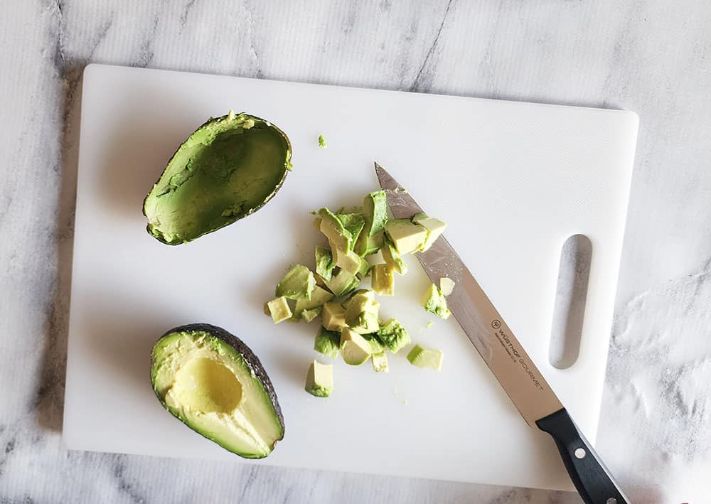 Avocado cut into peices on a cutting board