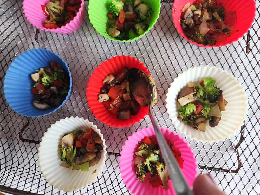 egg bites adding vegetables to silicone cups