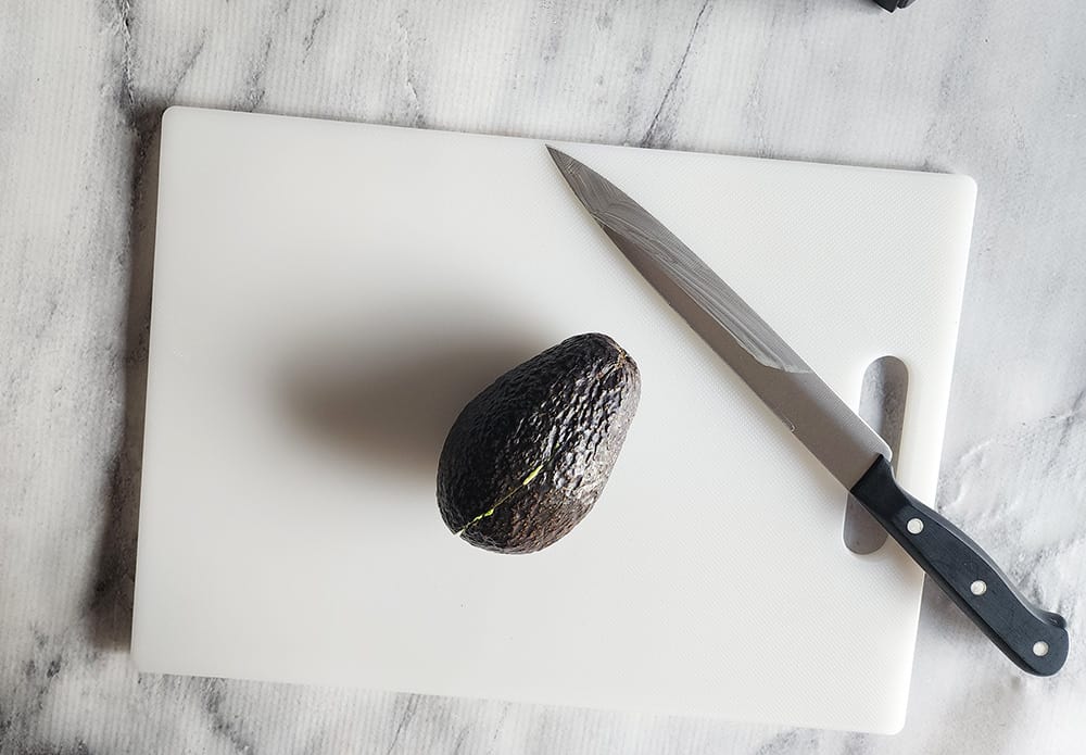 an avocado on a cutting board