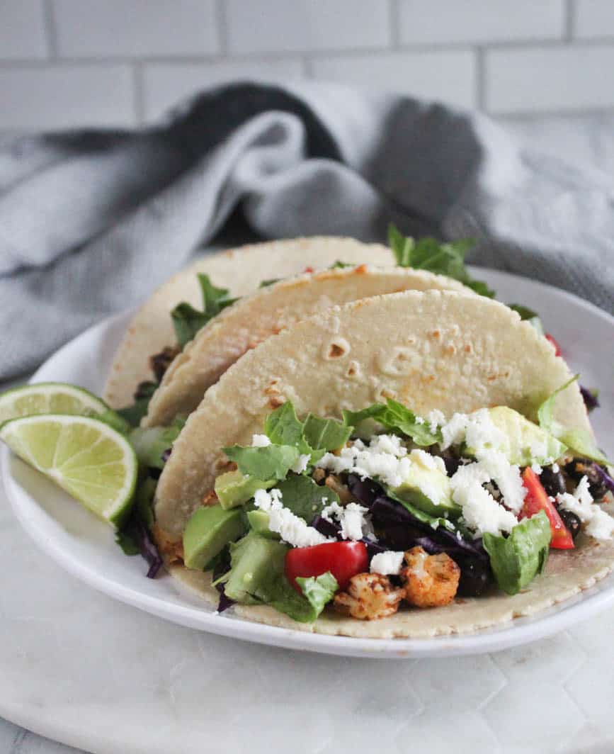 a close up picture of three cauli tacos on a plate