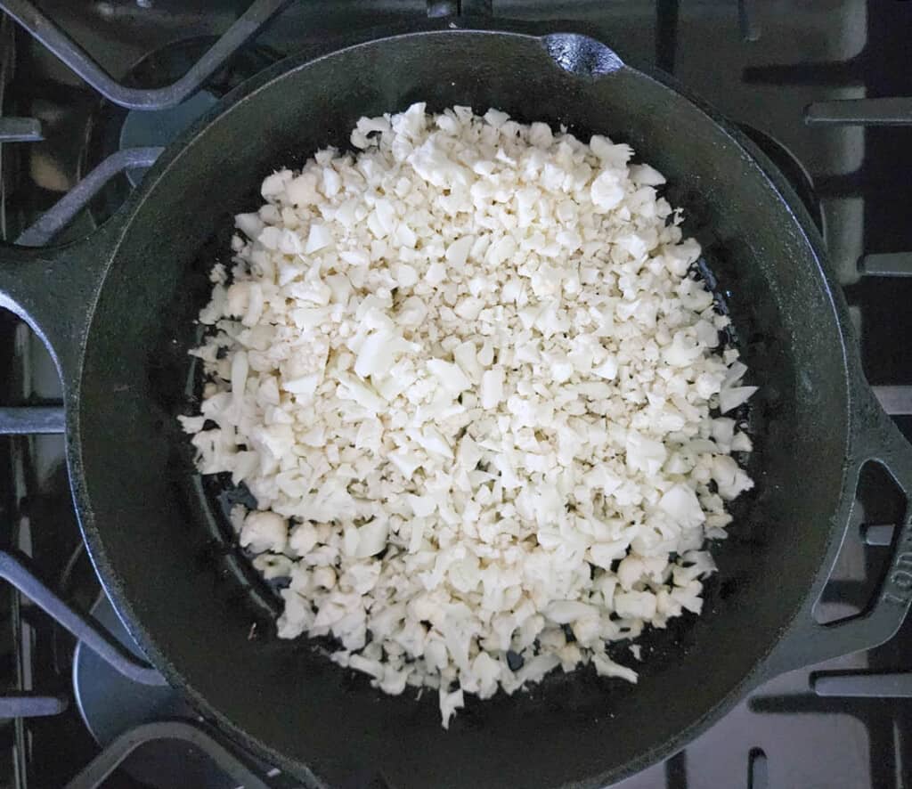 Step 1 cauliflower cooking in a skillet