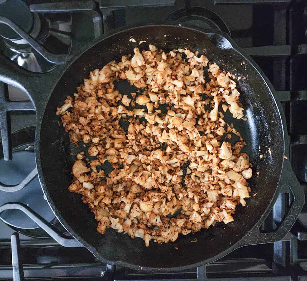 a picture of step 2, cauliflower cooking with seasoning