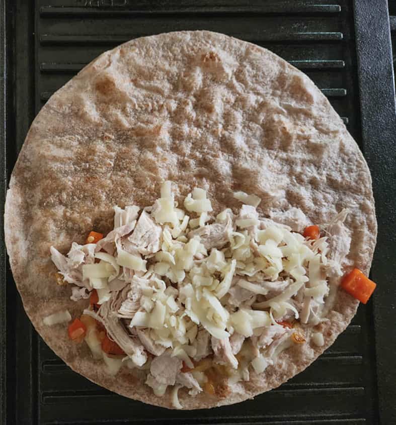 Process step 3 a tortilla half covered with filling