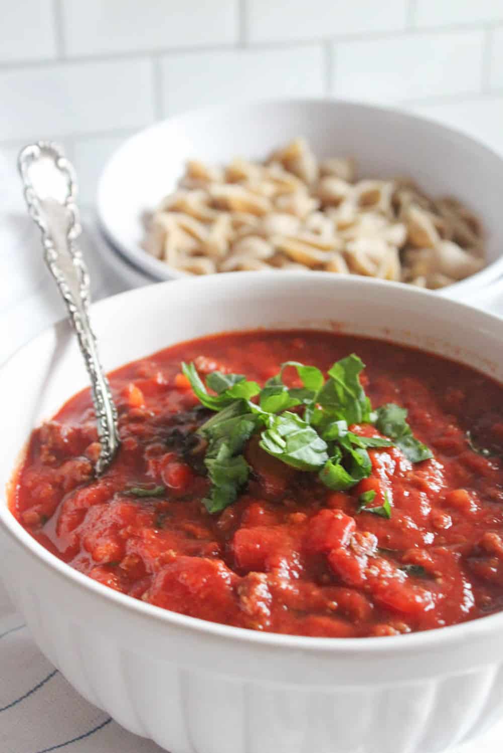 a picture of a bowl of meat sauce with a spoon