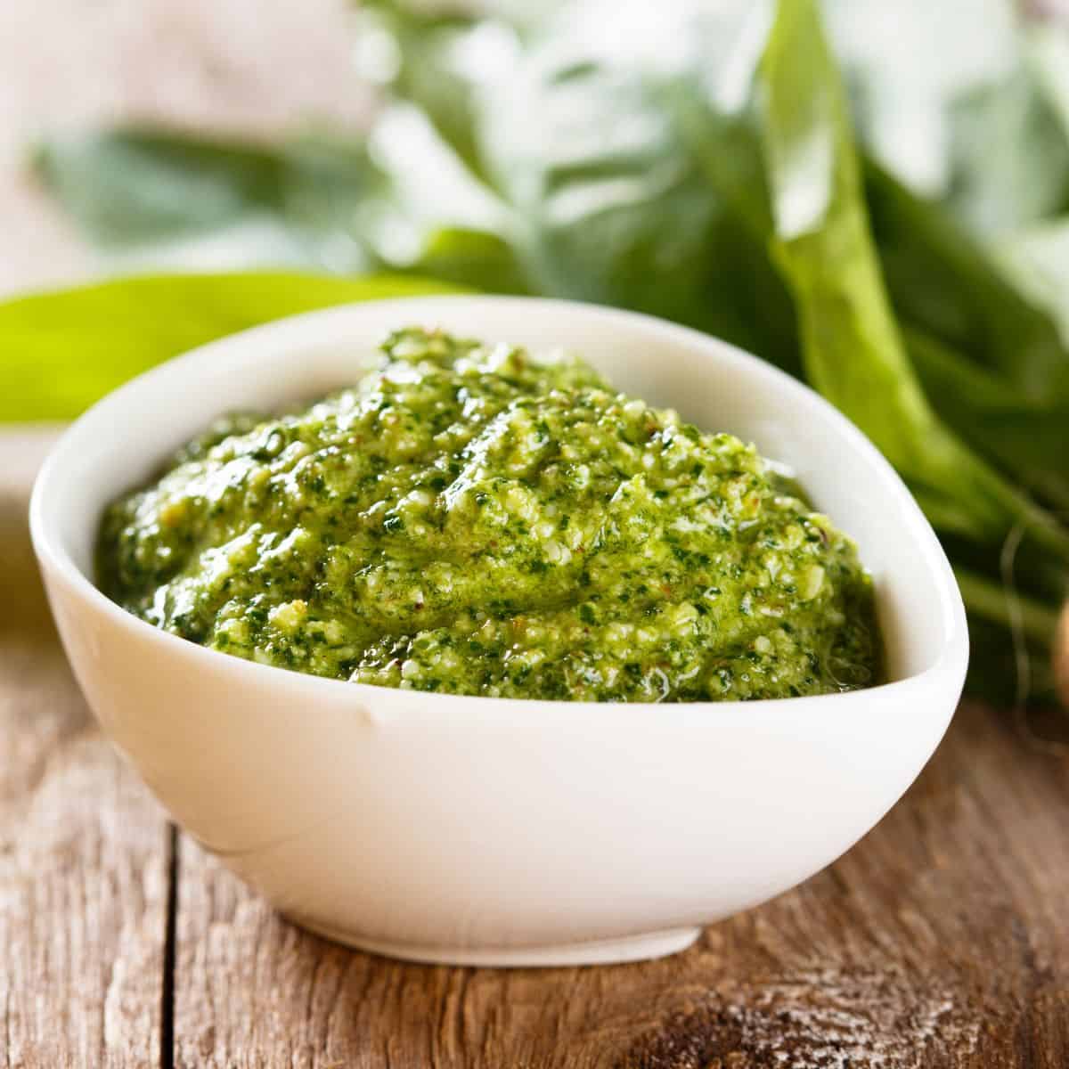 a picture of pesto sauce in a white bowl