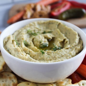 Close up of dill pickle hummus in a bowl