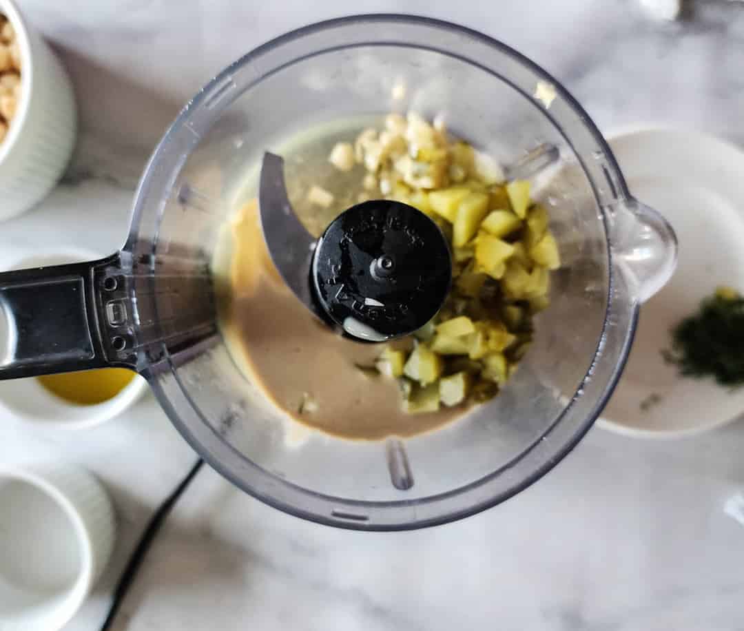 Dill pickle hummus step 1 add pickles, tahini and garlic