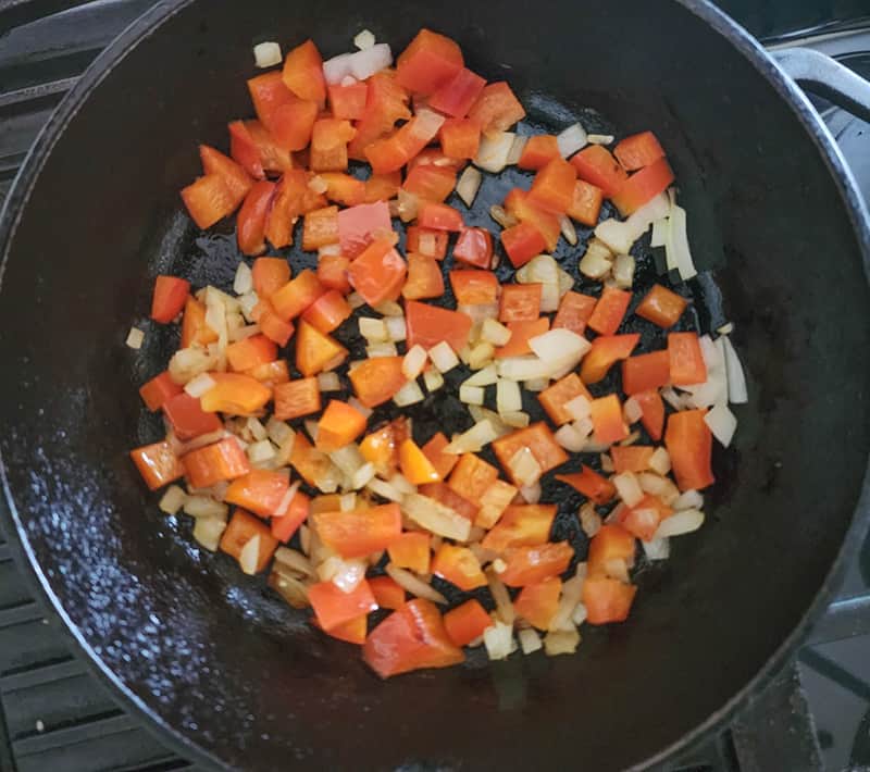 step 1 peppers cooking in a skillet