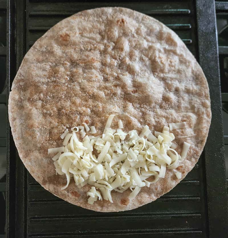 step 2 tortilla half covered with cheese