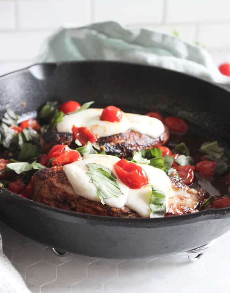 cooked caprese chicken in a skillet