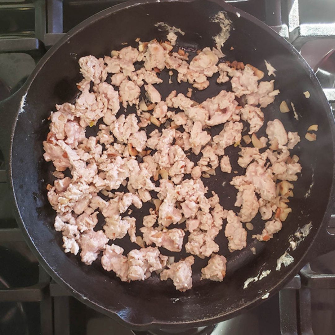 process step 1: ground chicken cooking in a cast iron skillet