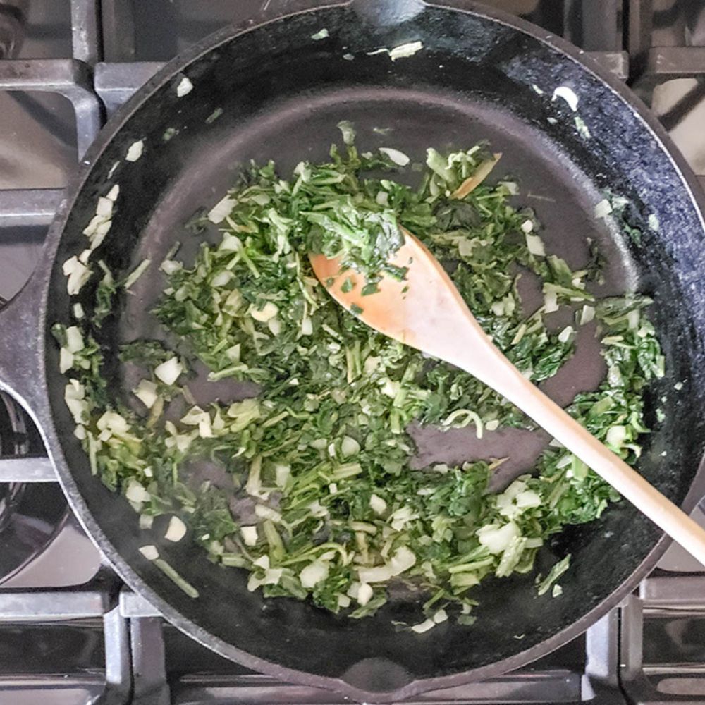 spinach balls process step, cooking spinach in a hot skillet
