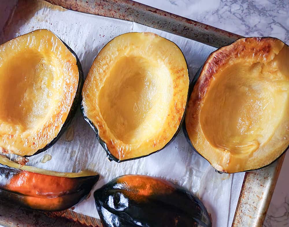 baked butternut squash halves on a baking sheet