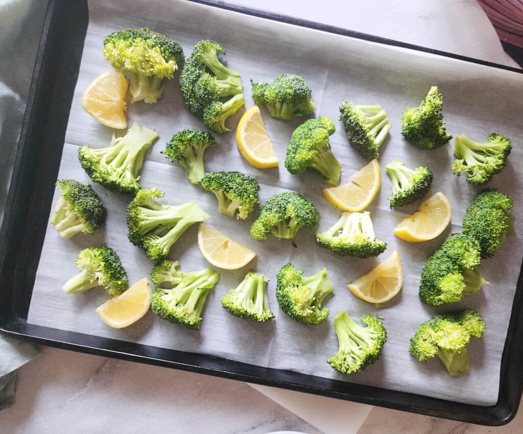 step 1: a picture of the broccoli on a tray with lemon slices