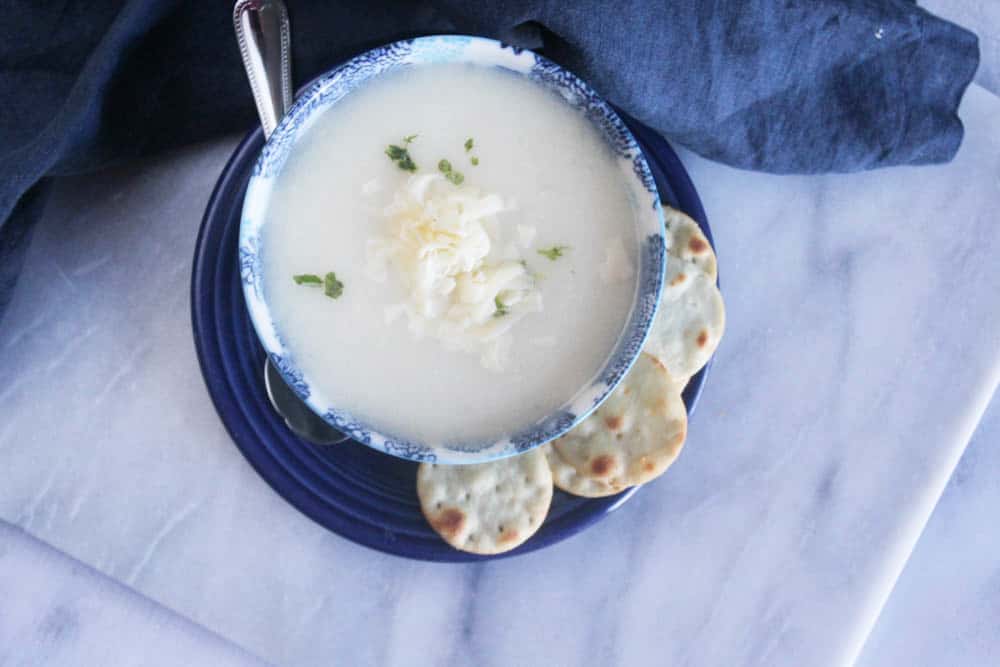 an overhead picture of cauliflower soup ina blue bowl