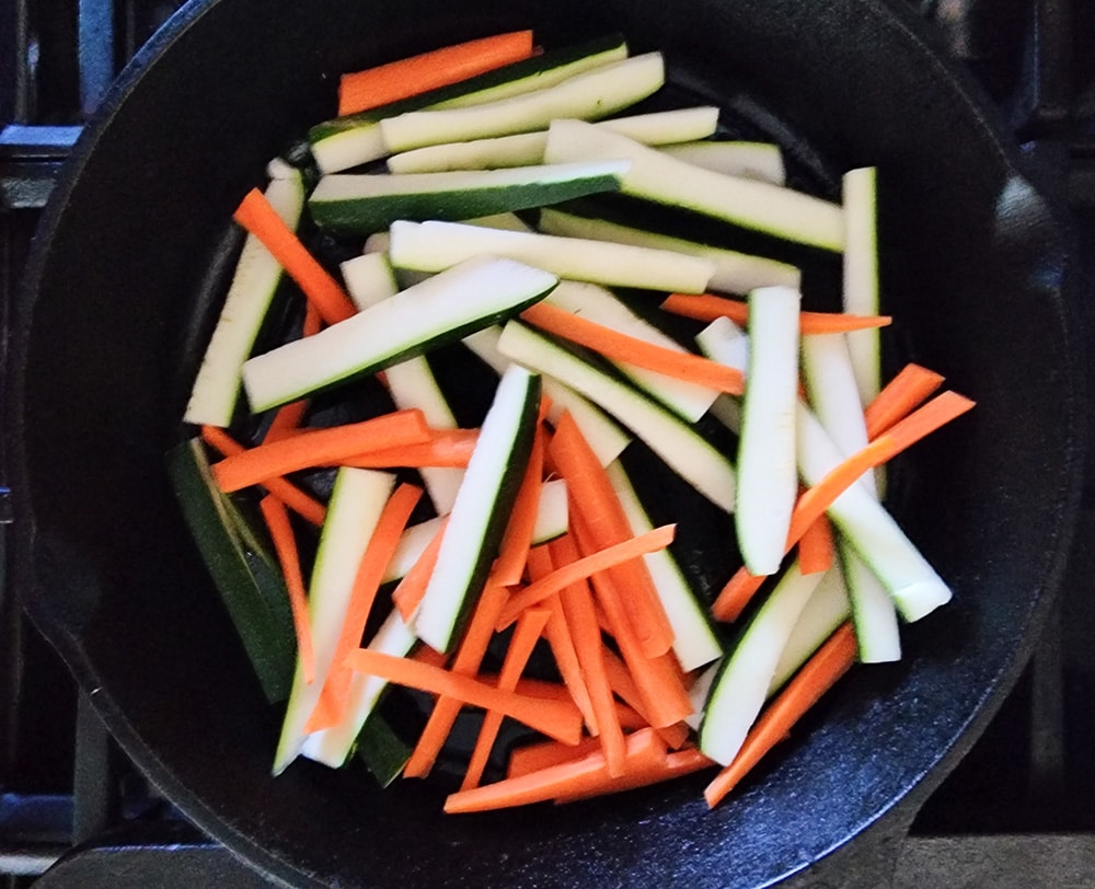 Zucchini and carrots process step 2 carrots and zucchini cooking in a skillet