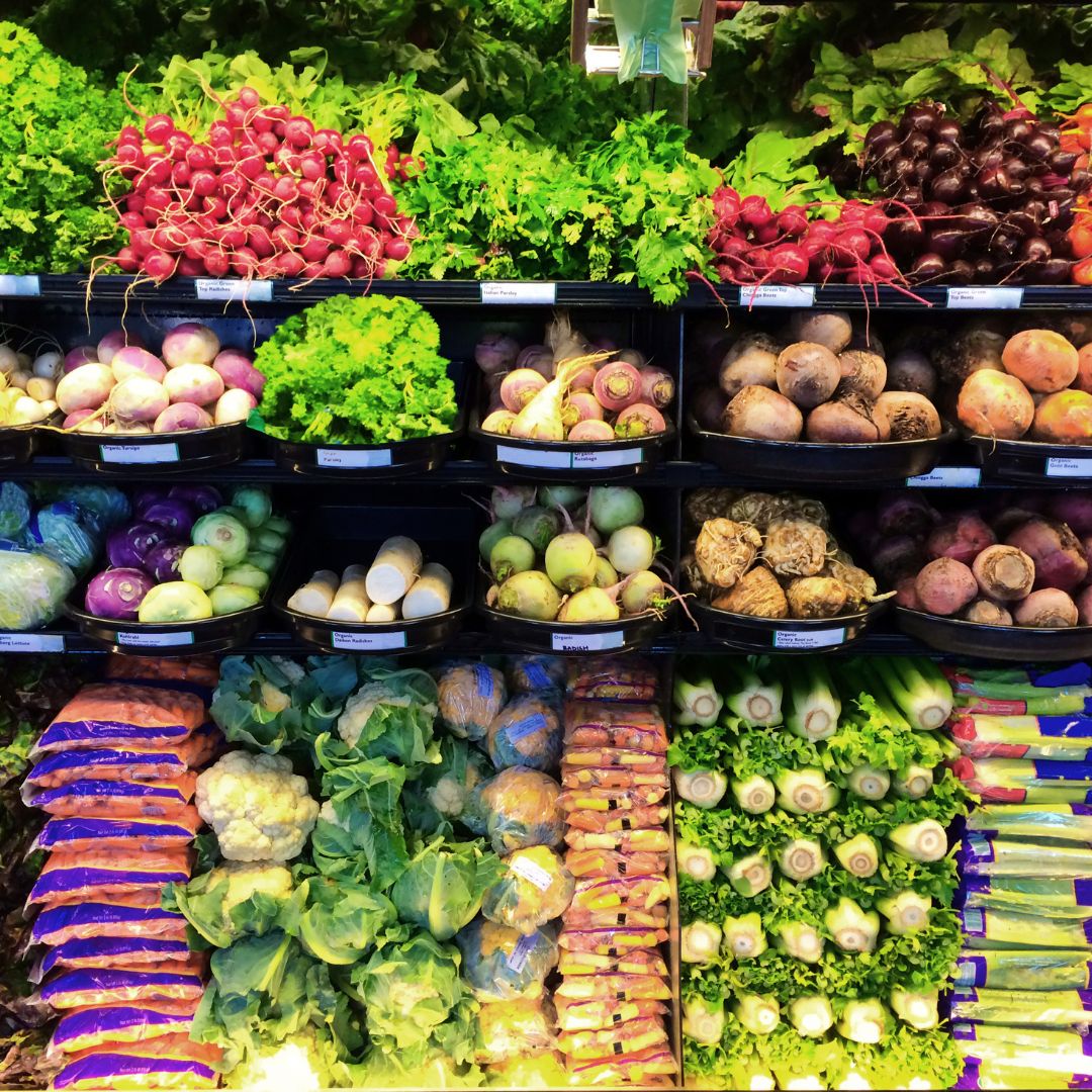a photo of produce on shelves in a supermarket