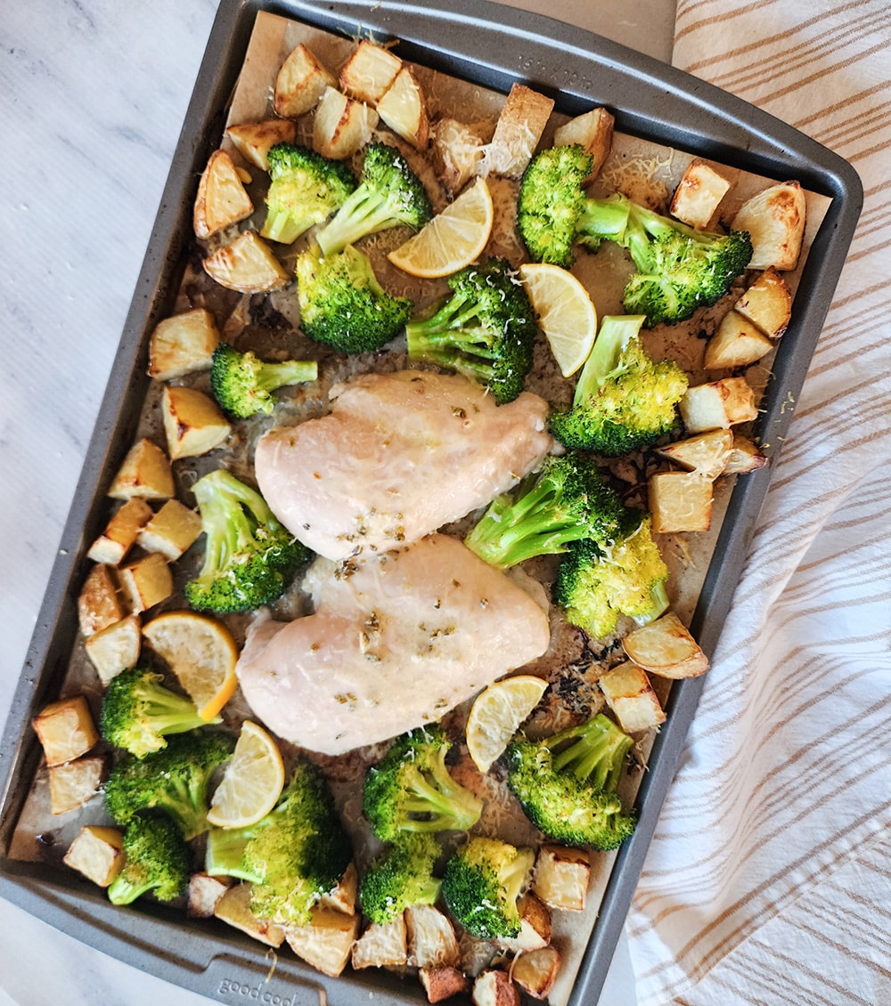 a picture of chicken broccoli and potatoes on sheet pan out of the