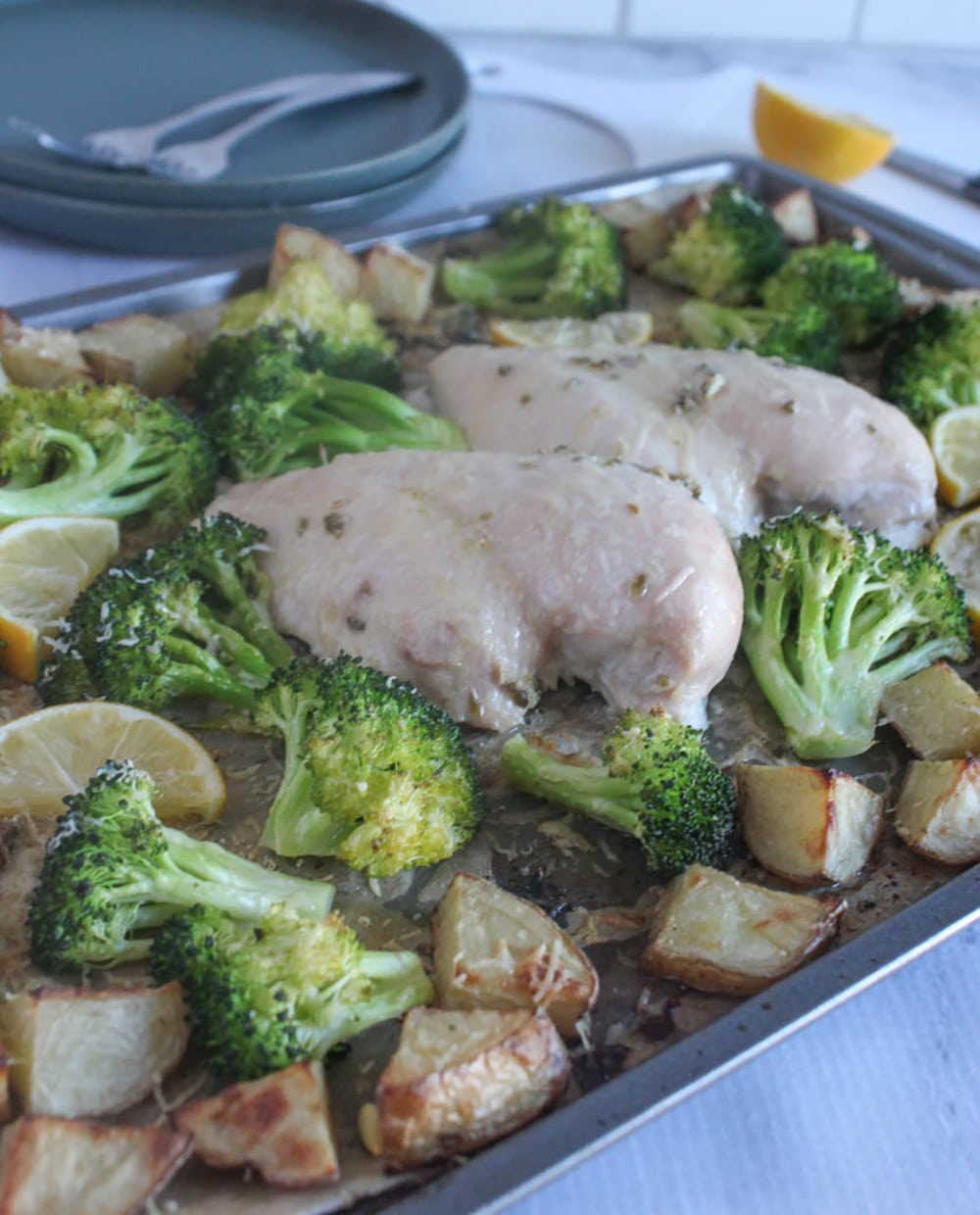 A picture of sheet pan chicken broccoli and potatoes out of the oven