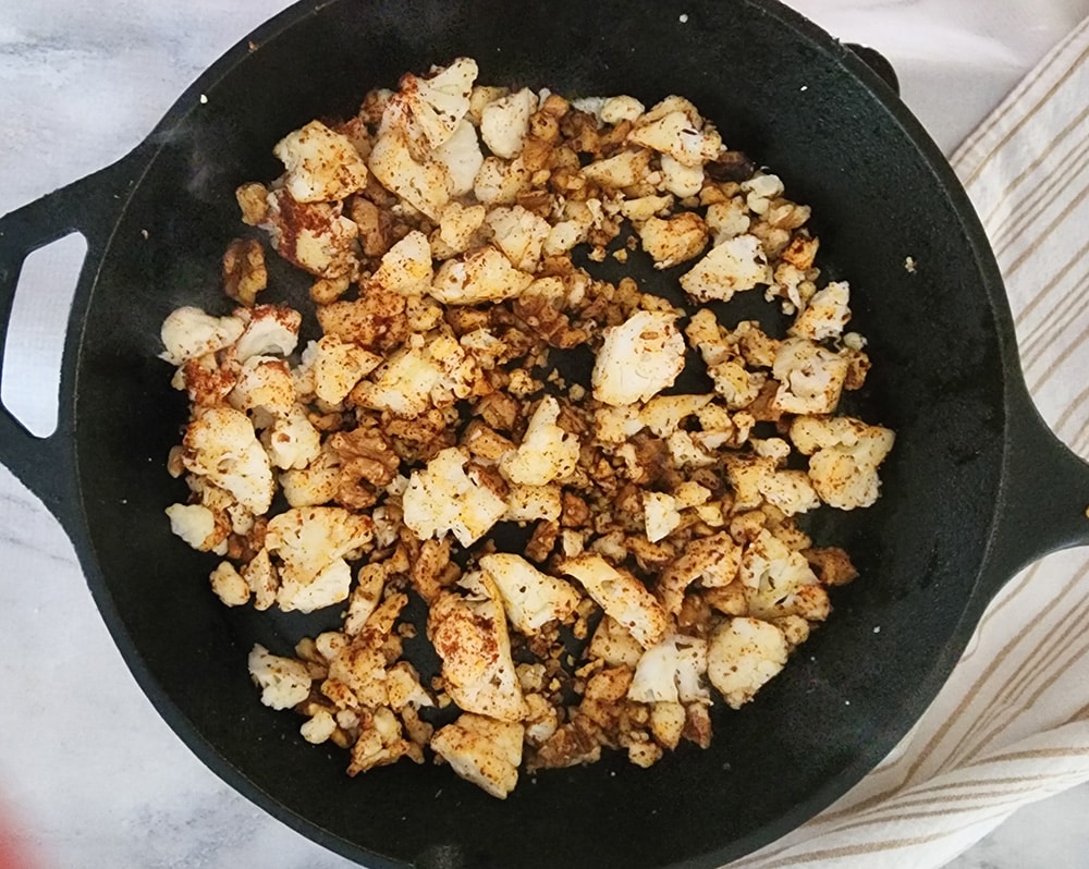 A picture of vegetarian taco meat in a skillet with the spices added
