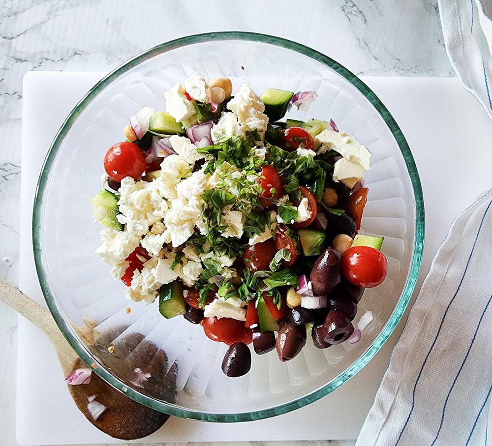 A picture of the salad ingredients with feta cheese crumbles on top
