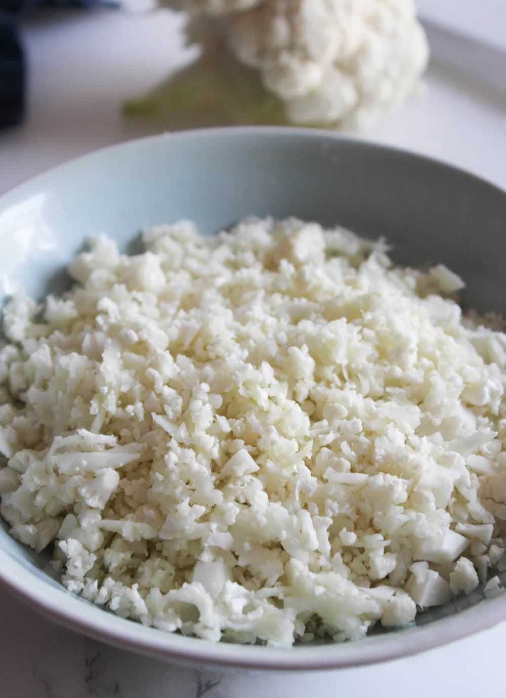 a picture of cauliflower rice in a blue bowl