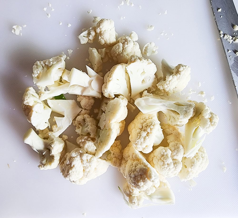 cauliflower florets cut on a cutting board