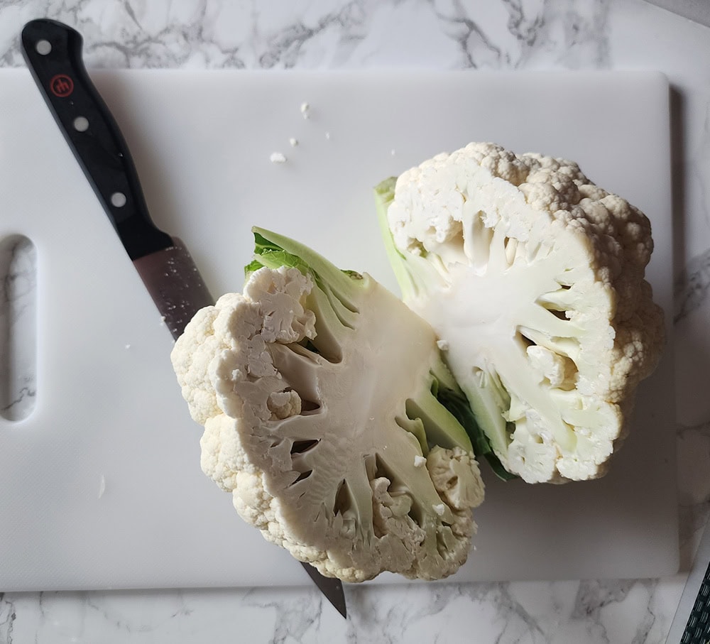 a picture of a whole head of cauliflower cut in half