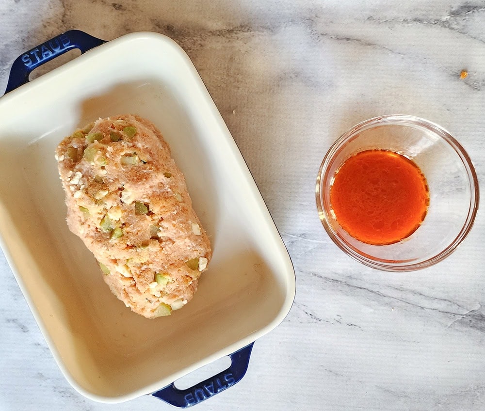 a picture of a formed meatloaf in a baking dish