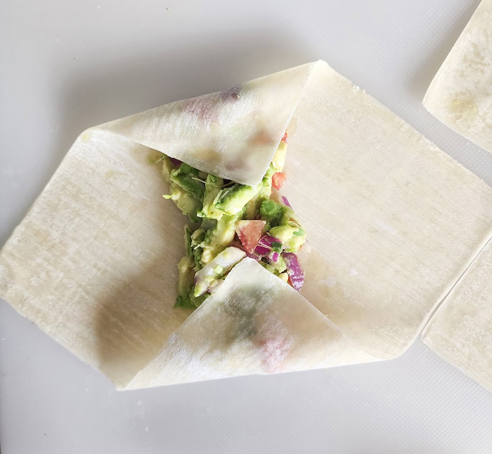 step 4: roll up the egg roll; fold in the top and bottom of the egg roll wrapper