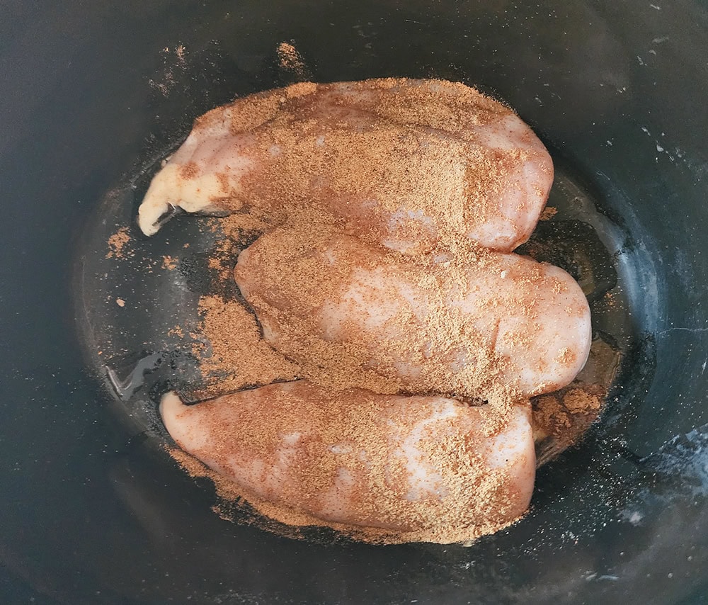 Process step 1. Chicken breasts in a slow cooker with spices on top