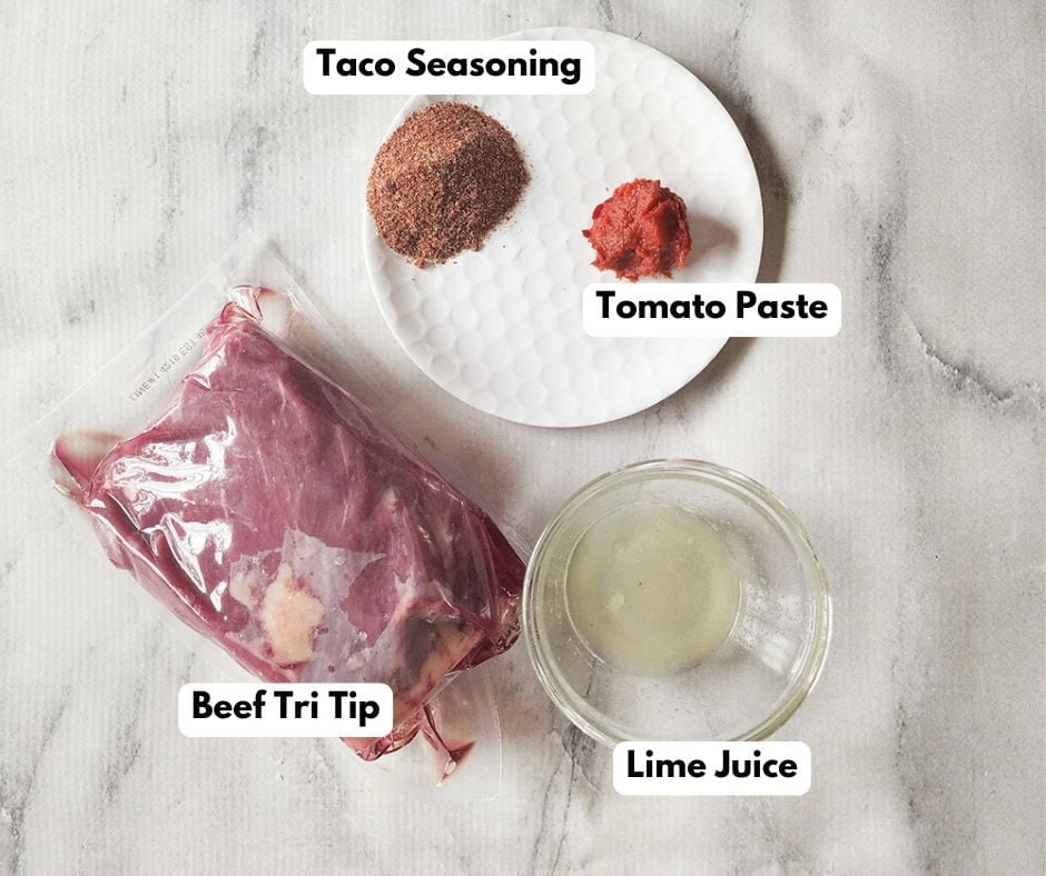 a picture of the ingredients needed to make slow cooker tri tip tacos: beef tri tip, lime juice, taco seasoning and tomato paste