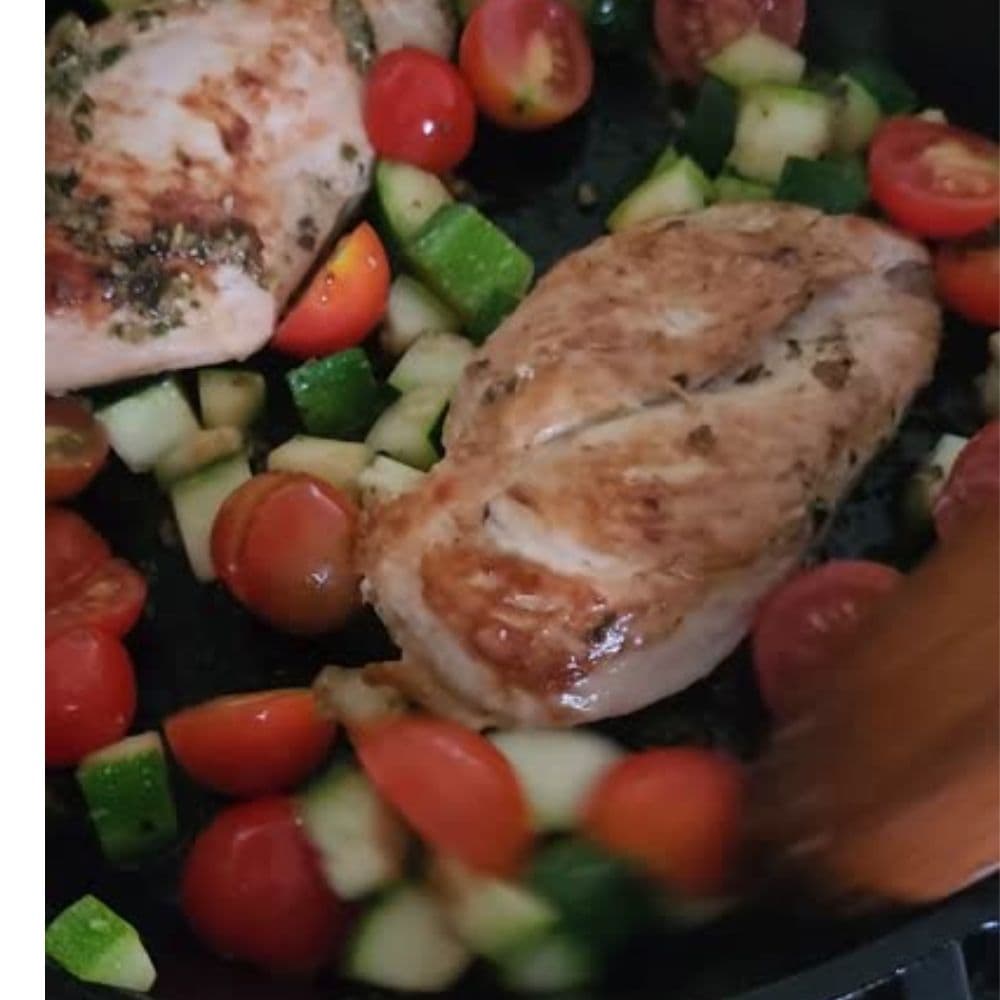 third process step, tomateos added to skillet with chicken and zucchini