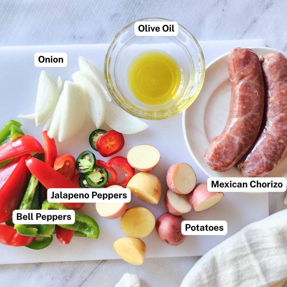 a picture showing the ingredients  needed to make mexican sausage and peppers: Chorizo sausage, potatoes, peppers, onions, olive oil