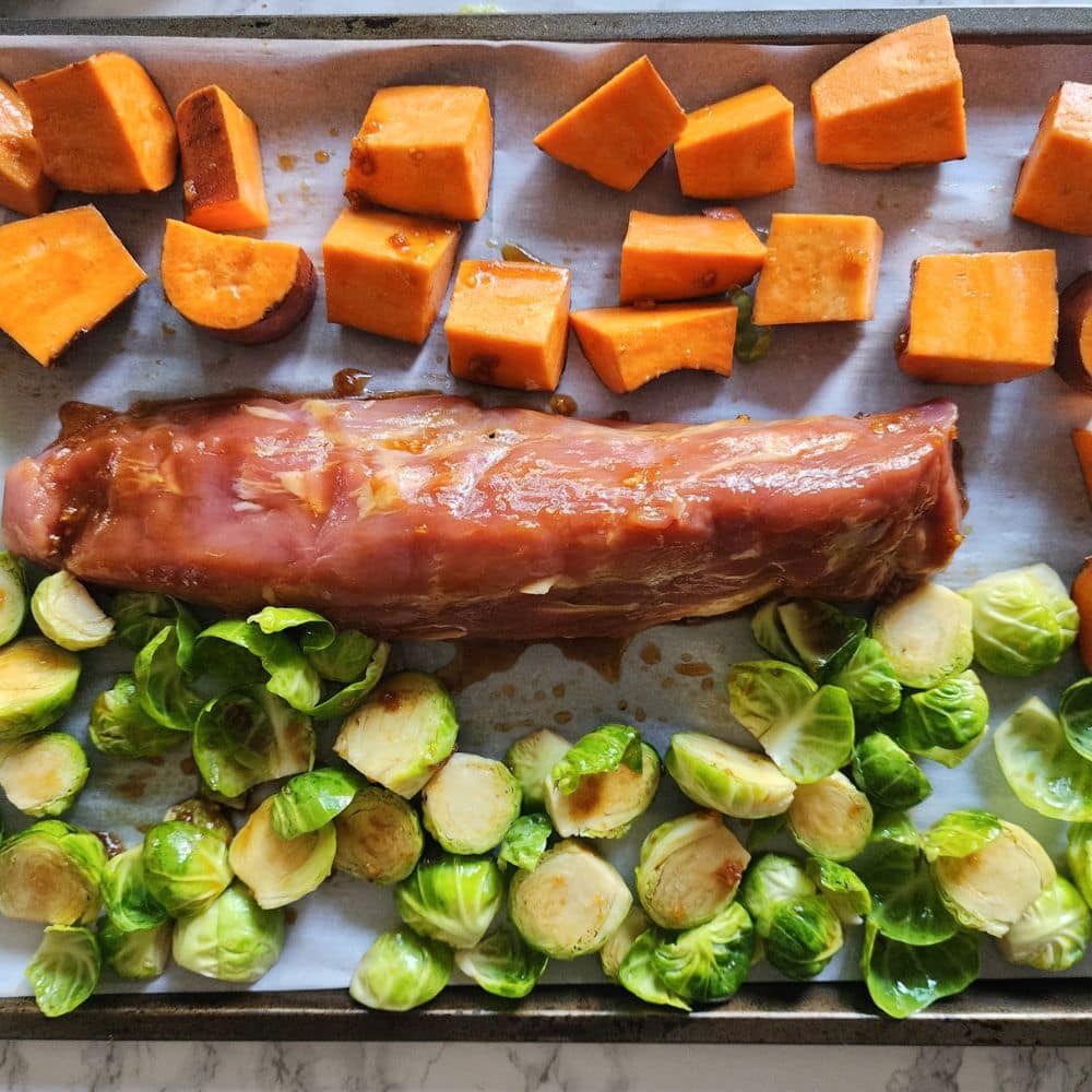 a picture of allof the ingredients on a sheet pan ready for the oven