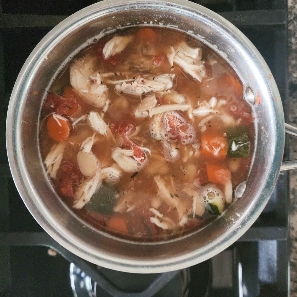 a picture of a pot of soup on the stove 