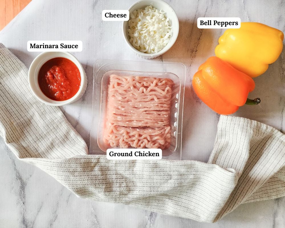 a picture of the ingredients needed to make this recipe which are bell peppers, ground chicken, marinara sauce and cheese